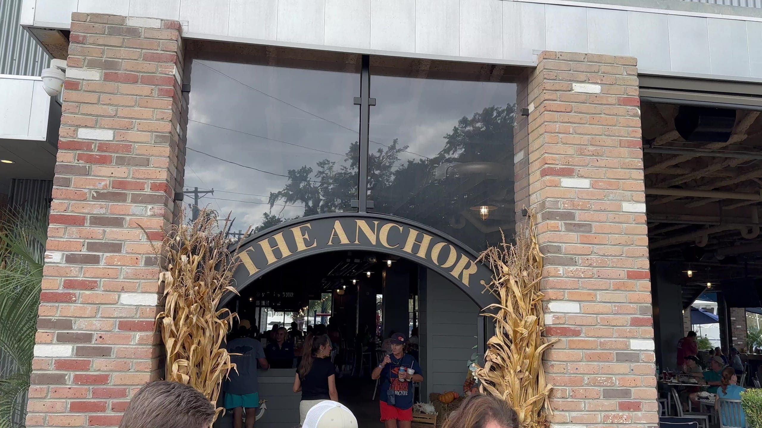 Brick piers and the arched sign over the entrance to The Anchor in Madisonville.